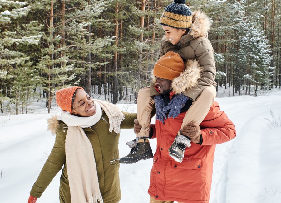 three people walking in the snow, parents and child, patient values