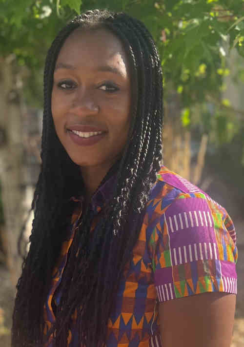 Provider Morgan Agagah-Parlato, standing outdoors, wearing a colorful shirt, smiling